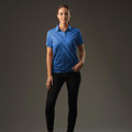 Woman wearing royal blue short-sleeve polo with tonal diagonal geometric pattern and open placket collar