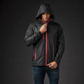 Man wearing graphite waterproof shell jacket with red zip contrast, adjustable hood, and side zip pockets