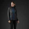 Woman wearing charcoal waterproof shell jacket with cobalt blue zip and chest pocket contrast detailing