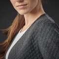 Woman wearing a charcoal grey quilted open cardigan with diamond-pattern texture and collarless neckline