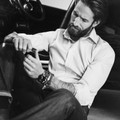Man in fitted white cotton twill dress shirt, long sleeves, seated casually in vehicle interior