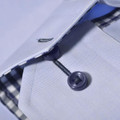 Close-up of pale blue twill shirt collar with navy contrast check lining and dark navy buttons