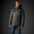 Man wearing charcoal and black two-tone quilted insulated parka with attached hood and front zip