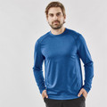 Man wearing a cobalt blue marl long sleeve performance top with raglan sleeves and crew neck