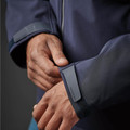 Close-up of navy Stormtech jacket cuff with rubberised branded tab and velcro adjustable wrist closure