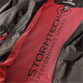 Close-up of charcoal shell jacket interior showing crimson red mesh lining with Stormtech Performance Apparel branding