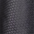 Close-up of charcoal hexagonal honeycomb textured fabric on a youth insulated thermal jacket