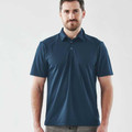 Man wearing a navy blue snag-resistant performance polo with three-button placket and smooth technical fabric