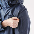 Close-up of navy waterproof jacket sleeve showing zip-entry pocket detail and smooth shell fabric