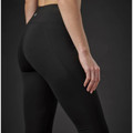 Model wearing black high-waist performance leggings with smooth fabric panelling, rear detail view