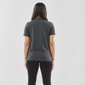 Back view of woman wearing a charcoal short-sleeve polo with smooth fabric and fitted silhouette