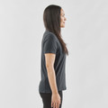 Woman wearing charcoal grey short sleeve polo with smooth front panel, side profile view