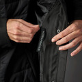 Close-up of black Stormtech jacket zip-off inner layer with branded zip pull and snap button detail