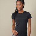 Woman wearing a black fitted crew neck active sports tee with short sleeves and smooth performance fabric