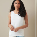 Model wearing a white sleeveless women's tank top with round neckline and clean smooth front panel