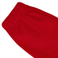 Close-up of red polar fleece jacket cuff showing elasticated hem and textured fleece fabric