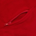 Close-up of red polar fleece fabric with matching red zip pocket detail