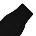 Close-up of black knit jumper sleeve showing ribbed cuff detail on kids heavyweight V-neck
