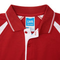 Red raglan sports polo with white contrast panels, tipped collar, and red button placket — flat lay detail shot