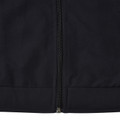 Close-up of black microfibre jacket showing centre-front zip and ribbed hem band