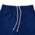 Royal blue microfibre track pants with elasticated waistband and white rope drawcord, flat lay close-up
