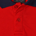 Red micro mesh kids polo with navy raglan collar and matching red buttons, close-up packshot