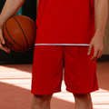 Bright red basketball shorts and matching singlet with white contrast piping detail at waistband