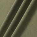 Sage green polo made from pique fabric, featuring a fine-textured knit construction with soft, draping folds.