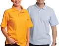 Man and woman wearing short sleeve pique polo shirts in gold and powder blue, three-button placket