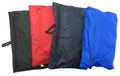 Four foldaway rain jackets with hoods in black, red, charcoal, and royal blue, shown laid flat and partially folded