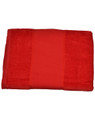 Folded red cotton velour beach towel with smooth central panel and textured terry borders