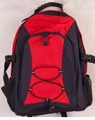 Red and black padded backpack with bungee cord lacing, zip front pocket, side mesh pockets and buckle straps