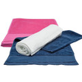 Hot pink, navy, and white cotton fitness towels flat lay, one rolled, showing hemstitched border detail