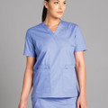 Woman wearing ceil blue v-neck scrub top with two front patch pockets and short sleeves