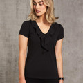 Woman wearing a black short sleeve top with V-neck and cascading ruffle front detail