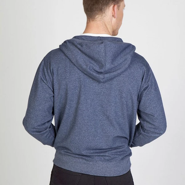 Back view of heather navy zip-up hoodie with hood and ribbed hem on male model
