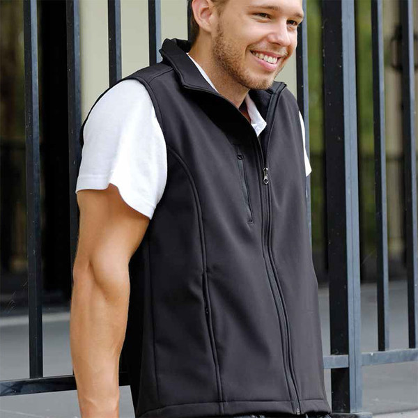 Charcoal softshell vest with hood and full zip, worn over white tee showing contrast layering