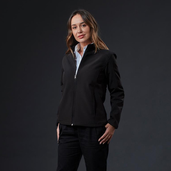 Woman wearing black stretch soft shell jacket with stand collar, full zip, and clean front panels