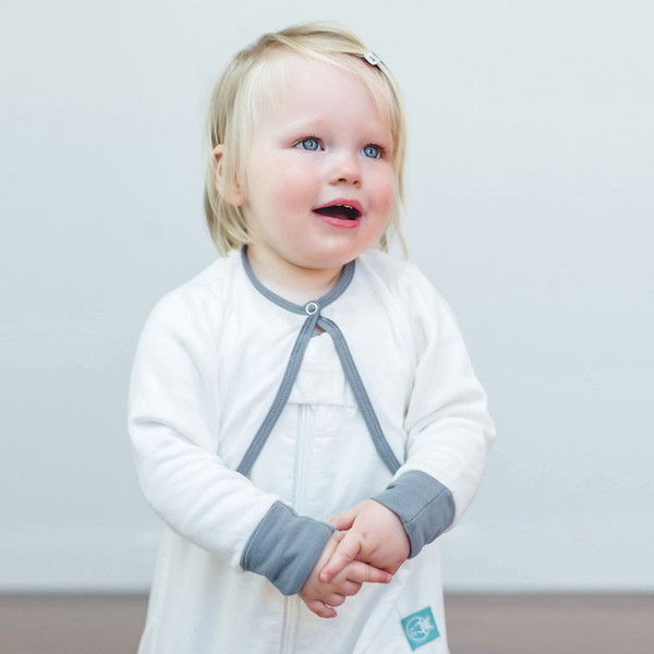 White long-sleeve baby cardigan with grey contrast trim and cuffs, featuring decorative bow ties at neckline