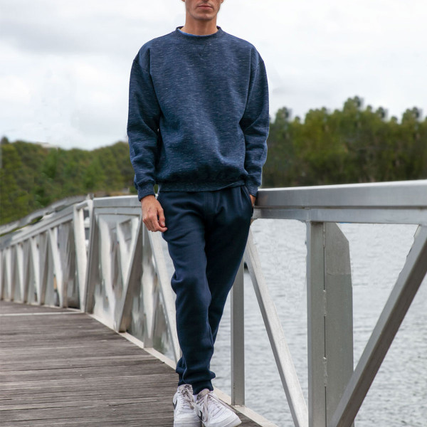 Navy fleece jogger trackpants with elasticated cuffs and drawstring waistband worn with matching sweatshirt