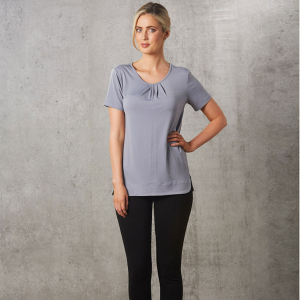 Lavender short sleeve top with gathered pleat detail at V-neckline worn with black pants