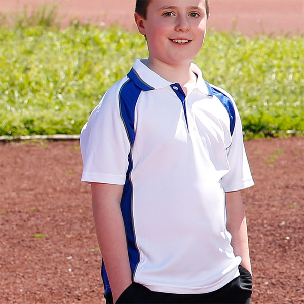 Child wearing white short sleeve polo with royal blue side panels and contrast collar, outdoors on a sports field