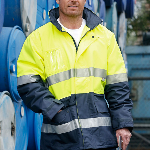 Man wearing fluoro yellow and navy hi-vis safety jacket with 3M reflective tape bands on chest and sleeves