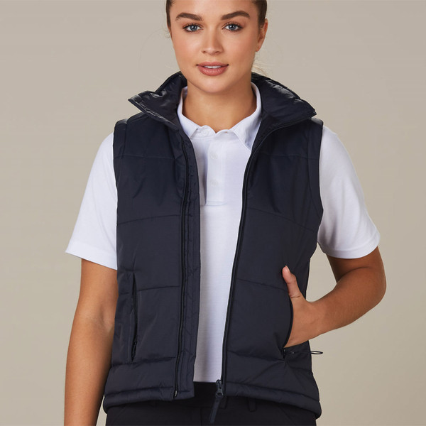 Navy padded puffer vest with full zip, stand collar, and front pockets worn over white tee