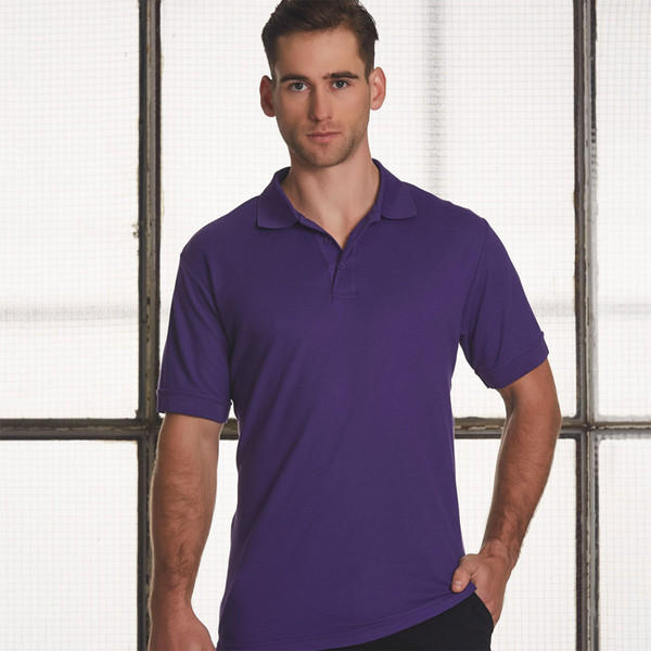 Man wearing a purple short sleeve polo shirt with ribbed collar and three-button placket