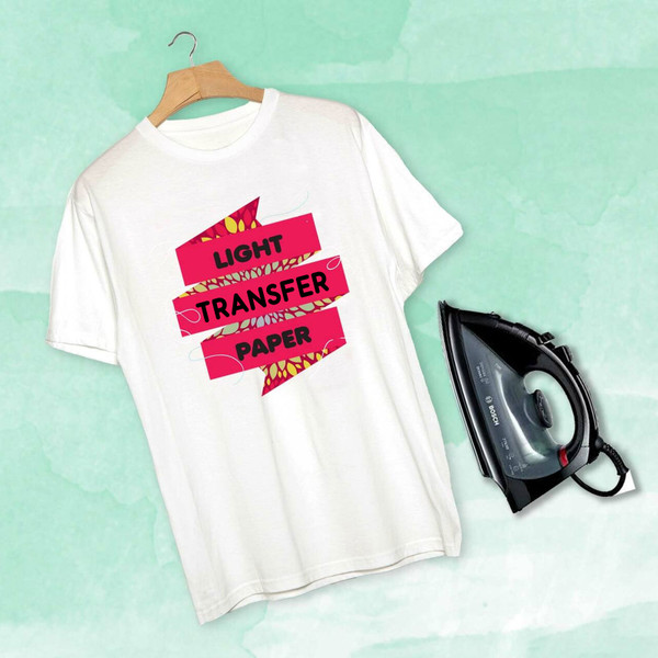 White t-shirt with bright pink heat transfer design displayed with iron on mint background