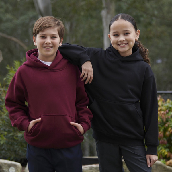 Two kids wearing heavy-duty pullover hoodies in burgundy and black with front kangaroo pockets, outdoor setting