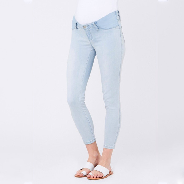 Ice blue maternity denim jeggings with fold-over belly panel, ankle grazer length, worn by model