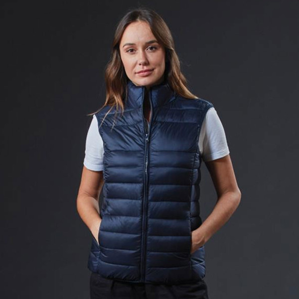 Navy quilted puffer vest with full zip closure and side pockets over grey shirt