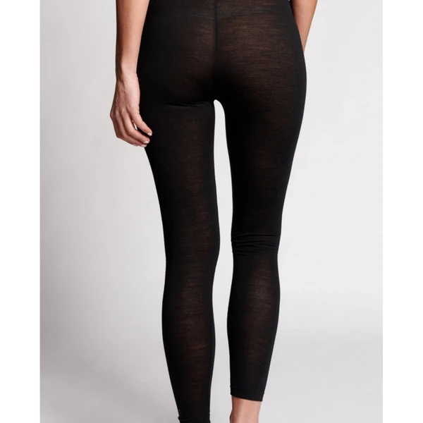 Black merino wool blend leggings shown from behind, featuring semi-sheer knit texture and fitted ankle length design